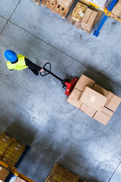 Worker moving boxes on a pallet truck